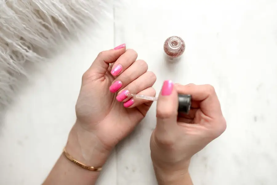 Pink polish being applied